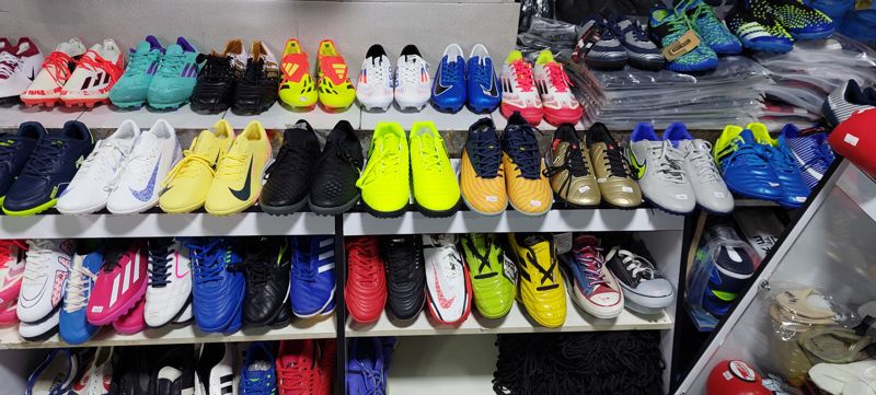 Стеллаж с футбольной обувью: бутсы и сороконожки Nike, Adidas и других брендов