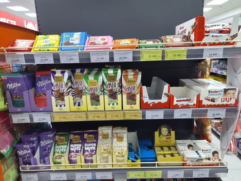 Полка с шоколадом Ritter Sport, Milka, Alpen Gold, Kinder, Рахат и Аленка, белые и жёлтые акционные ценники