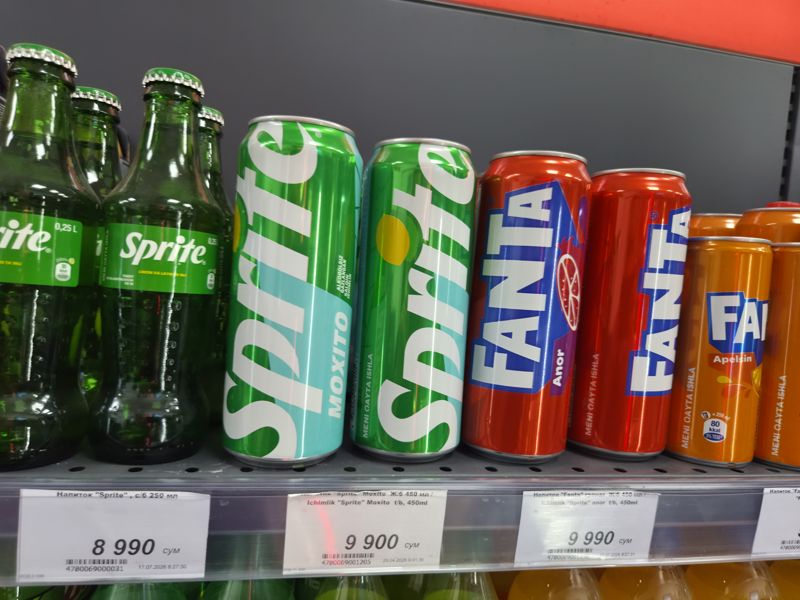 Полка с газировкой Sprite и Fanta в бутылках и банках, три ценника