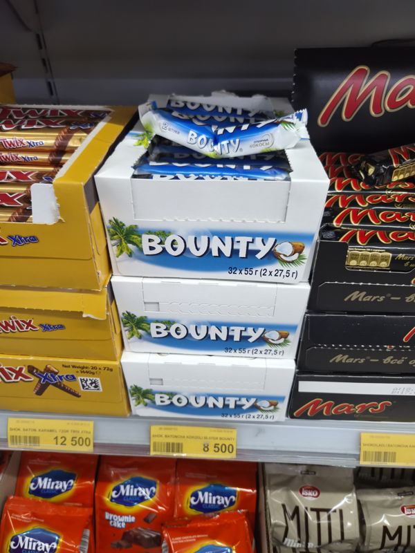 Havas: коробки батончиков Bounty (32 × 55 г) и Mars, слева Twix Xtra, снизу кексы Miray и печенье Isko Miti