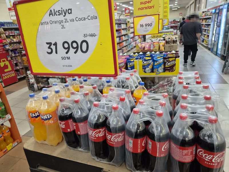 Горка с бутылками Fanta и Coca-Cola по 2 л под ценником «Aksiya»; справа бункер с чипсами Cheers под вторым ценником