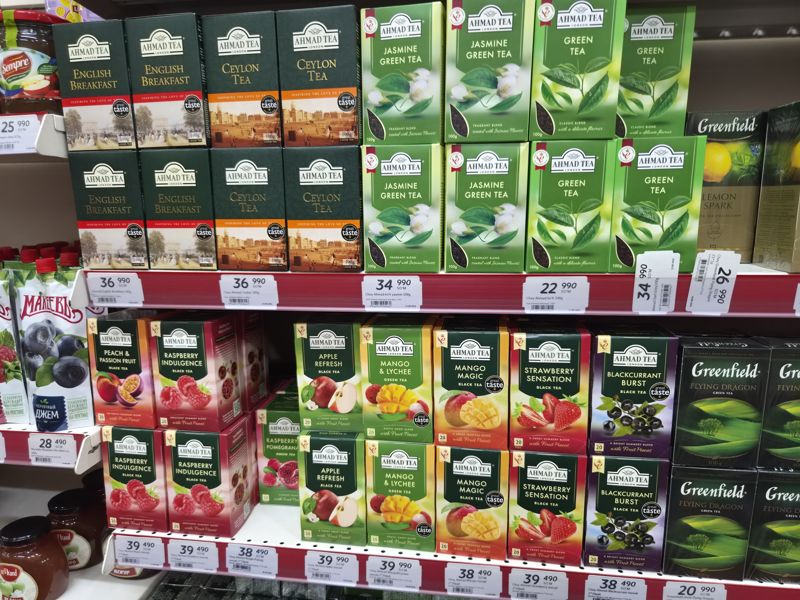 Чай Ahmad Tea листовой и в пакетиках, Greenfield на торговой полке: белые ценники с ценами и штрихкодами