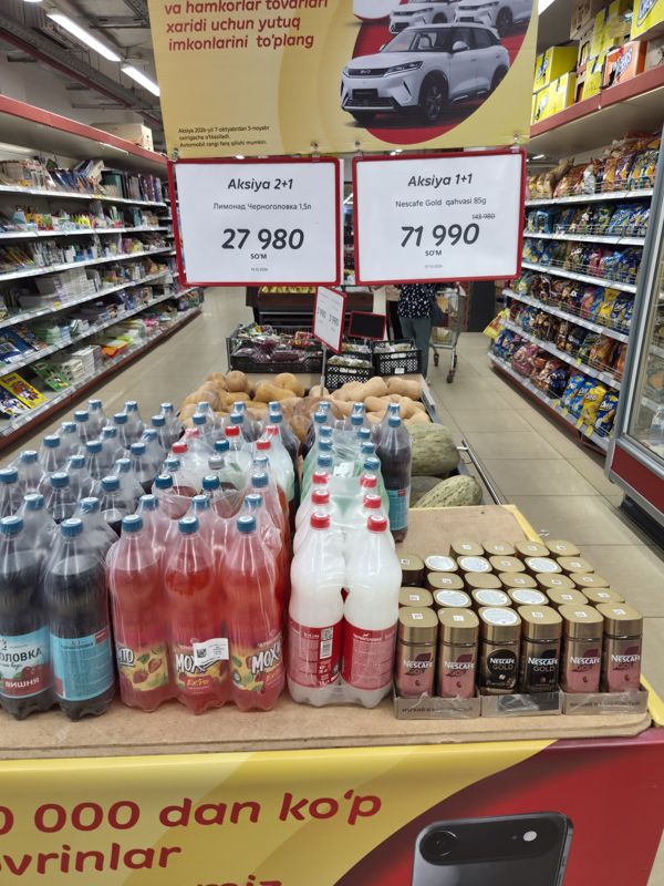 Островная выкладка в Korzinka: лимонады Черноголовка 1,5 л и растворимый кофе Nescafe Gold с акционными ценниками «Aksiya 2+1» и «Aksiya 1+1»