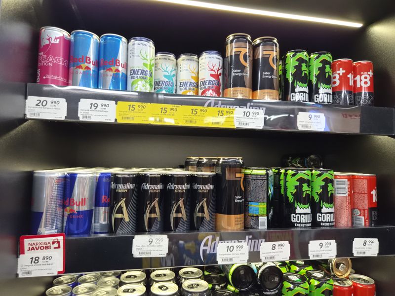 Холодильная витрина с энергетиками Red Bull, Borjomi Energia, Saber, Gorilla, Adrenaline Rush, Flash, 18+ и полочные ценники; жёлтые ценники на Borjomi Energia, красная плашка «Narxiga javob» у Red Bull