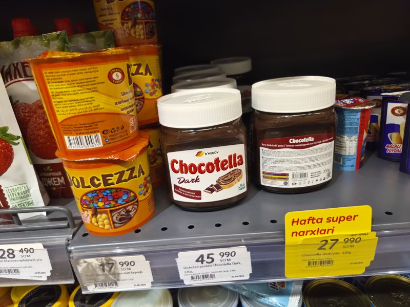 Шоколадная паста Chocotella и Dolcezza на полке, ценники и акционный жёлтый «Hafta super narxlari»