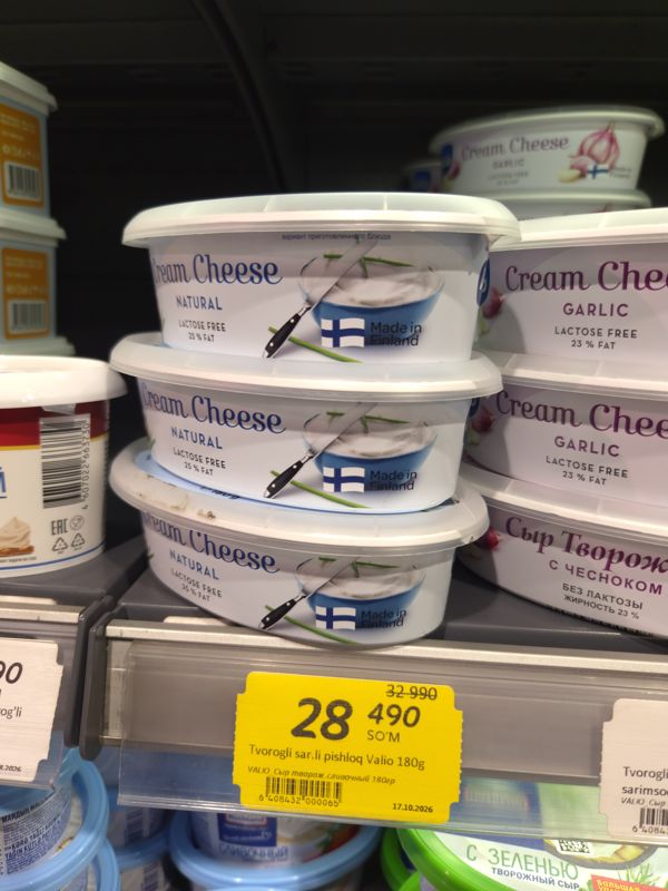 Сливочный творожный сыр Valio Cream Cheese Natural 180 г без лактозы на полке холодильника, жёлтый ценник со скидкой.